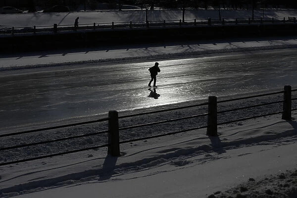 A skater is silhouetted on the Rideau Canal in Ottawa