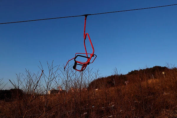 A ski lift chair hangs at the abandoned Alps Ski Resort located near the demilitarized
