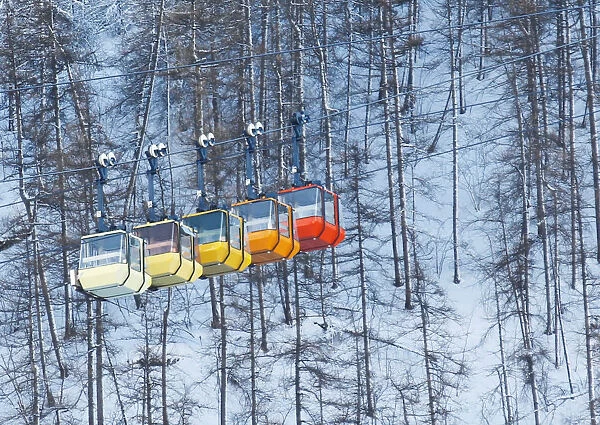 Ski lift chairs are pictured on snow-covered mountain in Saint-Pancrace as winter weather