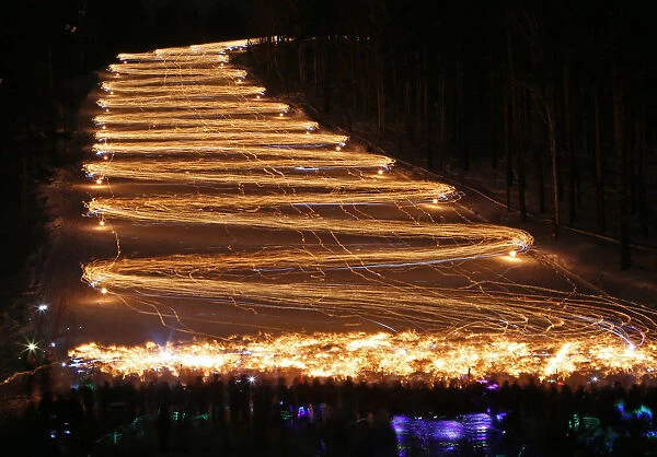 Skiers and snowboarders descend from a slope during an annual festival in Zheleznogorsk