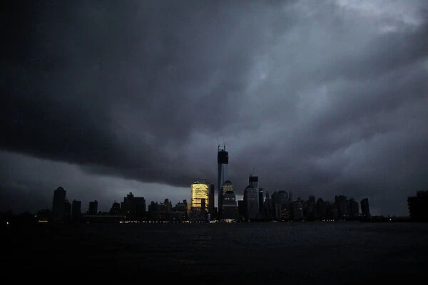 The skyline of lower Manhattan is in darkness except for Goldman Sachs building after a