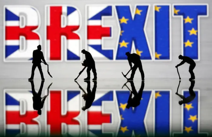 Framed Print : Small toy figures are seen in front of a Brexit logo in this illustration picture