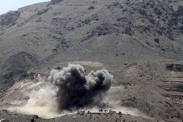 Smoke billows from a Noqum mountain after it was hit by an air strike in Yemens capital