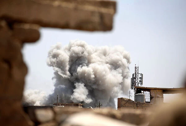 Smoke billows at the position of the Islamic State militants after it was hit by a rocket