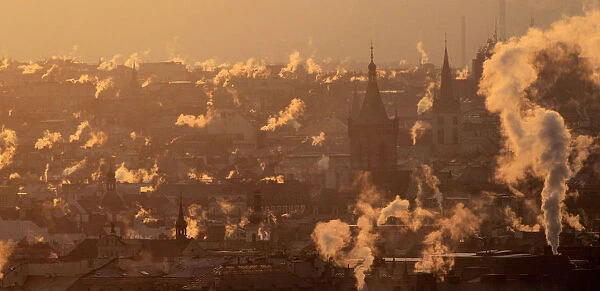 Smoke billows over the rooftops of downtown Prague