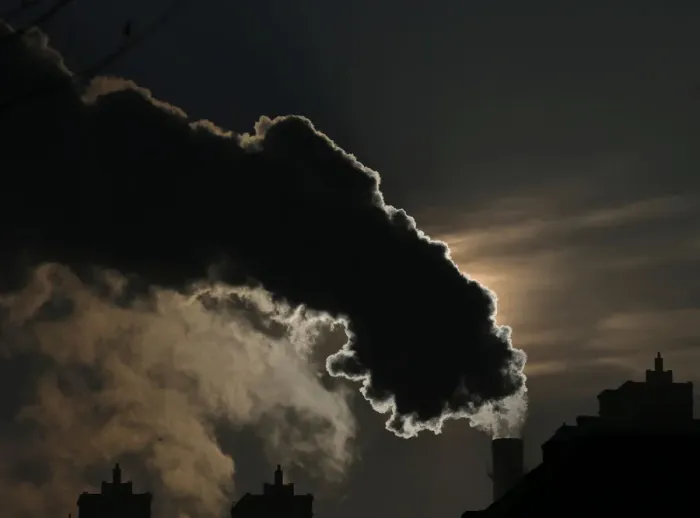Framed Print : Smoke from a chimney is silhouetted against the rising sun in the northern city of Harbin Framed Print : Smoke from a chimney is silhouetted against the rising sun in the northern city of Harbin
