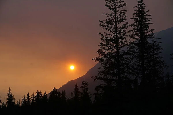 Smoke creates a red hazy sunset from the Swan Lake Fire on the Kenai Peninsula, in Seward