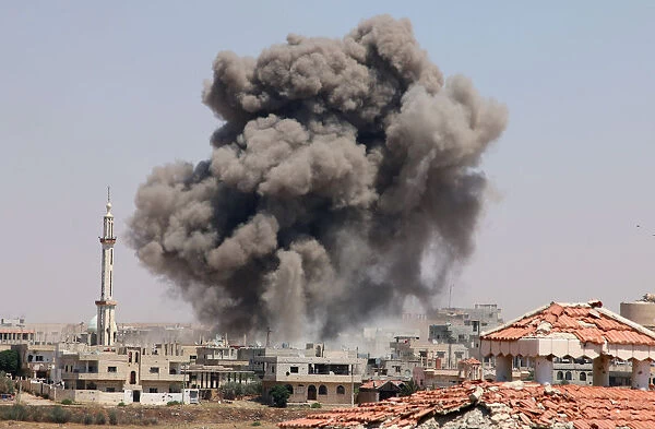 Smoke rises after airstrikes on a rebel-held part of the southern city of Deraa