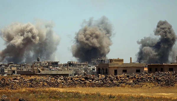 Smoke rises from al-Harak town, as seen from Deraa countryside
