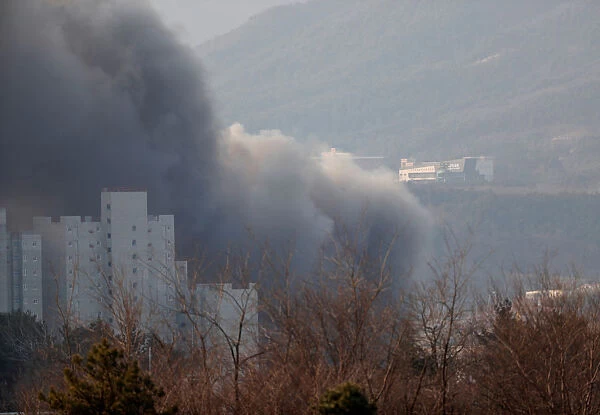 Smoke rises from a cafe after a fire in Gangneung