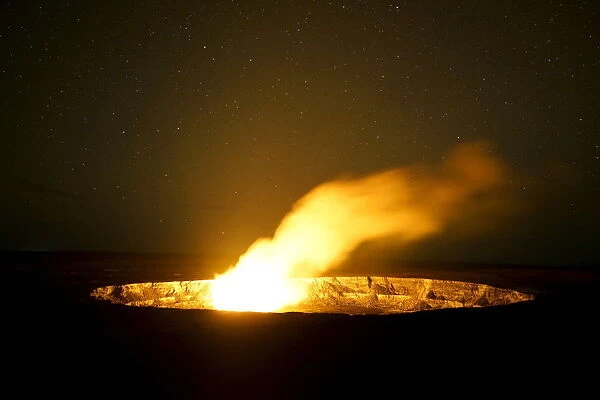 Smoke rises from the Kilauea Volcano caldera at night in Hawai i Volcanoes National Park