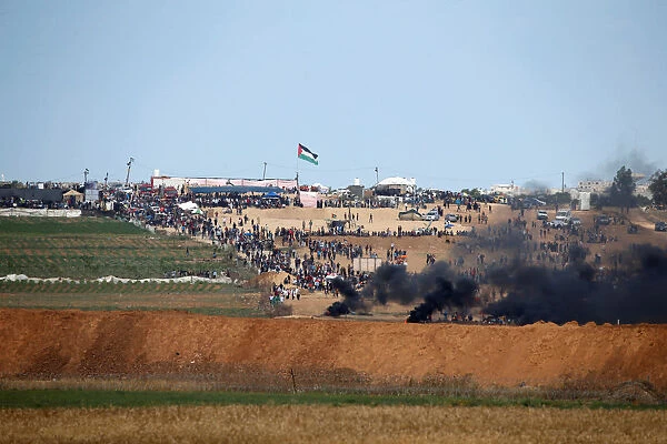 Smoke rises as Palestinians protest near the border fence on the Gaza side of the