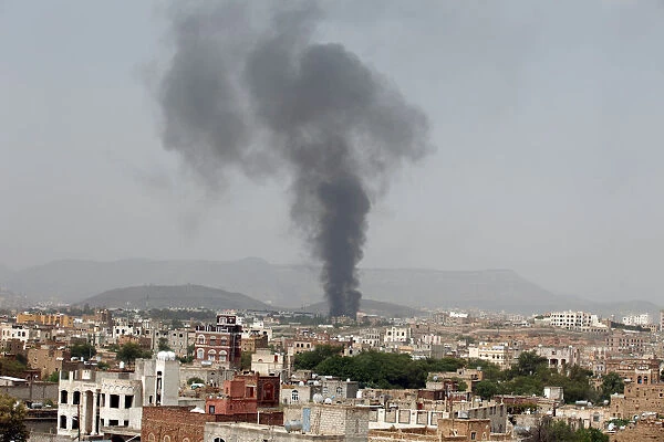 Smoke rises from a snack food factory after a Saudi-led air strike hit it in Sanaa