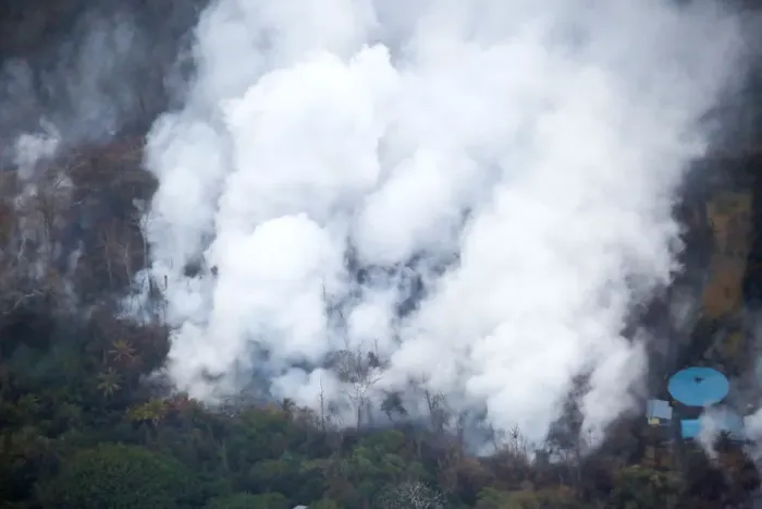 Framed Print : Smoke and steam rise from a lava flow in the Leilani Estates subdivision during ongoing