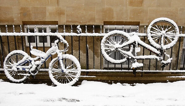 Snow-covered bikes are seen outside Corpus Christi College in Oxford, southern England
