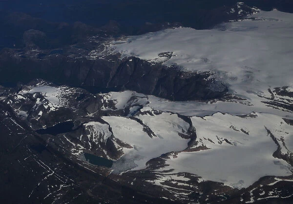 Snow-covered mountains are seen from an atmospheric research aircraft en route to the