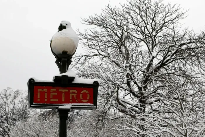 Framed Print : Snow covers a Metro sign and tree branches as winter conditions with snow Framed Print : Snow covers a Metro sign and tree branches as winter conditions with snow