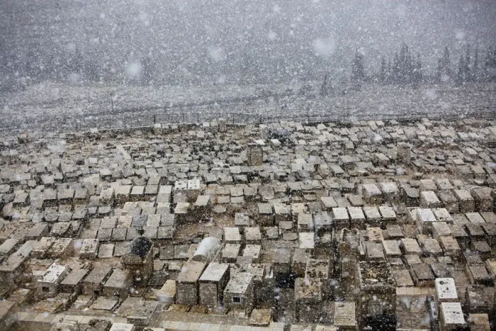 Framed Print : Snow falls on top of graves at the Mount of Olives cemetery in Jerusalem Framed Print : Snow falls on top of graves at the Mount of Olives cemetery in Jerusalem