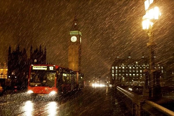 Snow falls over the Houses of Parliament in London