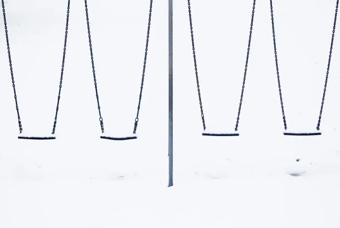 Framed Print : Snow sits on childrens swings at a playground in Lyminge near Folkestone in southern Framed Print : Snow sits on childrens swings at a playground in Lyminge near Folkestone in southern