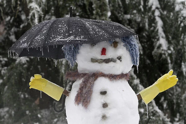 A snowman with an umbrella is covered in ice in a Renton, Washington neighborhood