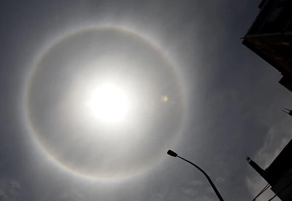 A solar halo, an optical phenomenon that appears around the Sun, is photographed in Lima