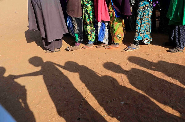 Somali internally displaced children queue before getting into a classroom at a school