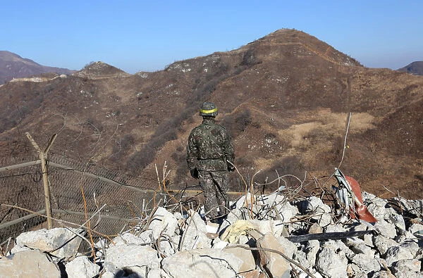 A South Korean army soldier stands guard at the Souths dismantled guard post inside the