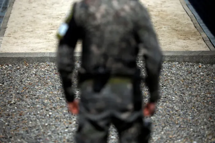 Framed Print : A South Korean soldier stands guard near the concrete borderline at the truce village of Framed Print : A South Korean soldier stands guard near the concrete borderline at the truce village of