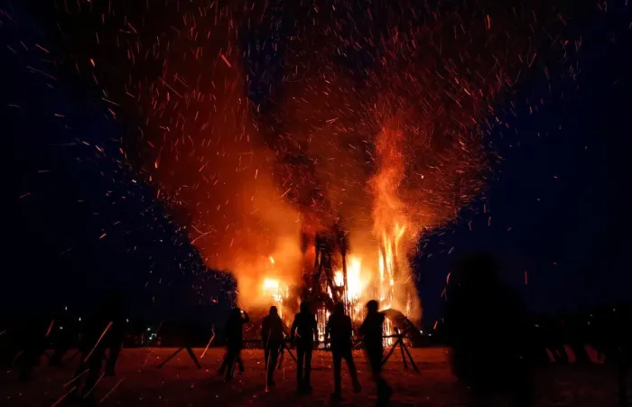 Framed Print : Spectators look at the burning installation during a performance devoted to Maslenitsa in Framed Print : Spectators look at the burning installation during a performance devoted to Maslenitsa in