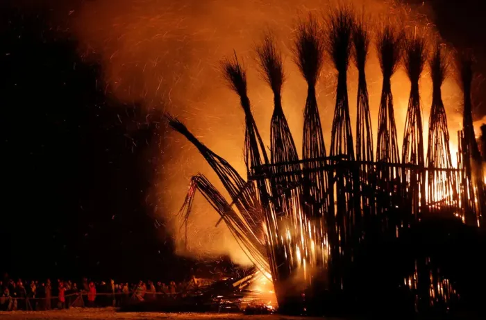 Framed Print : Spectators look at the burning installation during a performance devoted to Maslenitsa in Framed Print : Spectators look at the burning installation during a performance devoted to Maslenitsa in