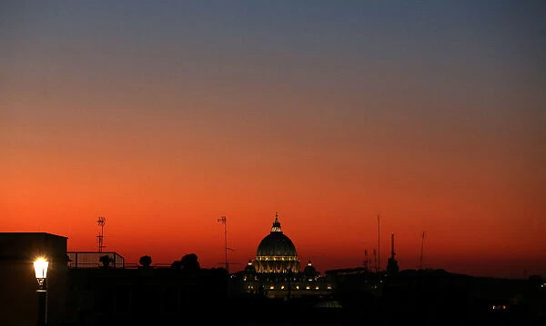 St. Peters basilica is seen at sunset from downtown Rome