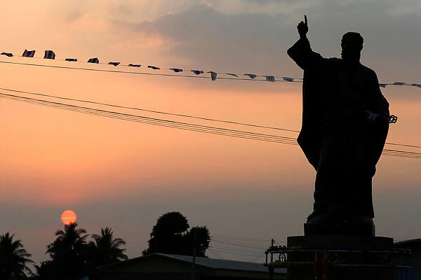 A statue of Jesus is seen at sunset, ahead of Pope Francis visit to Thailand