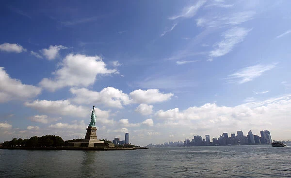 Statue of Liberty and New York City skyline seen from tour boat from New York Harbor