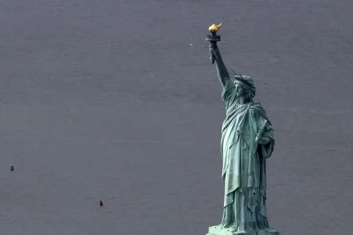 Framed Print : The Statue of Liberty is seen from this aerial view after Liberty Island was hit by Framed Print : The Statue of Liberty is seen from this aerial view after Liberty Island was hit by