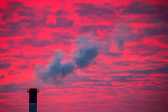 Framed Print : Steam rises from a smoke stack at sunset in Lansing, Michigan Framed Print : Steam rises from a smoke stack at sunset in Lansing, Michigan