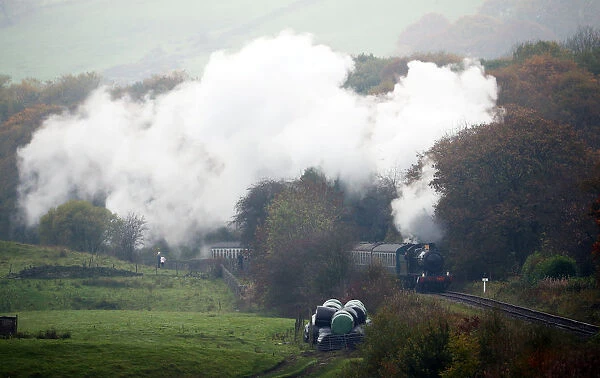 A steam train travels along the East Lancashire Railways line near Irwell Vale station