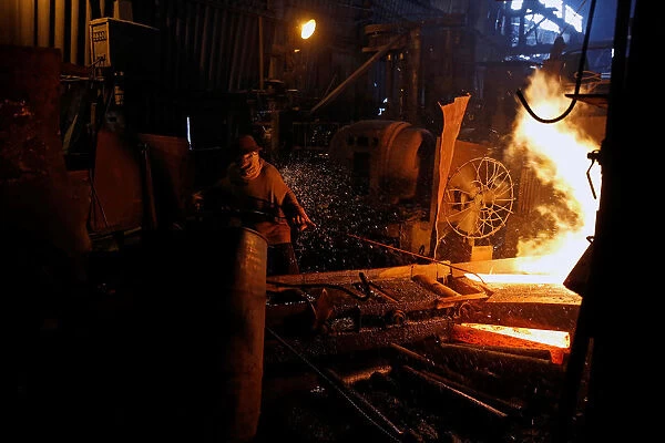 A steelworker is seen in a mill in Chau Khe village outside Hanoi