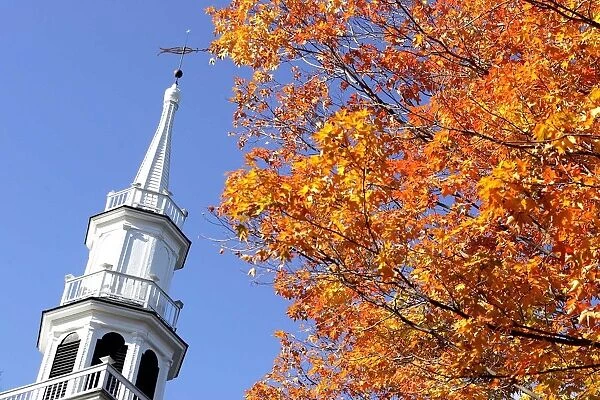 The steeple of The First Congregational Church is juxtaposed with fall colors in Sharon