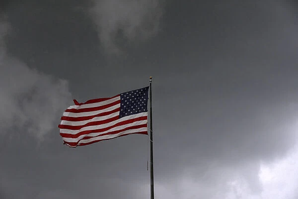 Storm clouds loom over an American flag in Convent