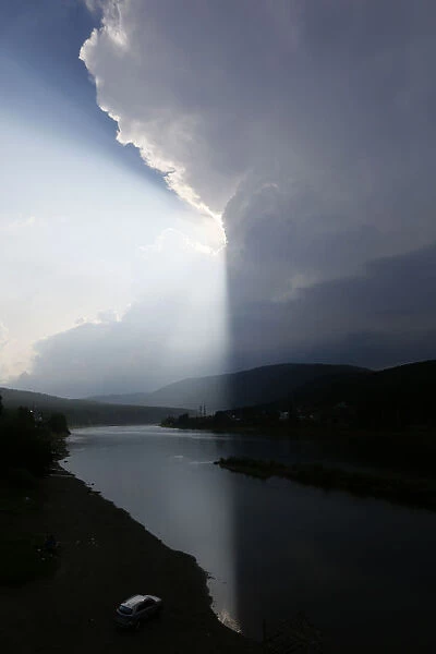 Storm clouds are seen over the Mana river in Taiga district near the village of Ust-Mana