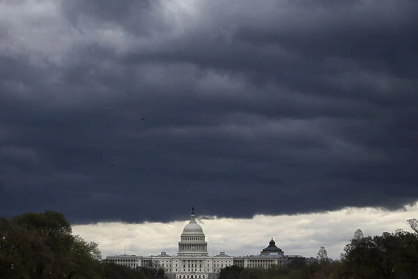 A storm front moves over the U. S. Capitol building as seen from the National Mall in