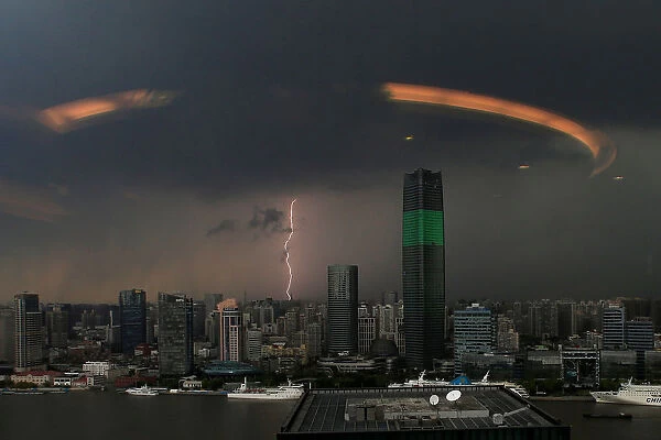 A streak of lightning is seen above the skyline of Shanghai