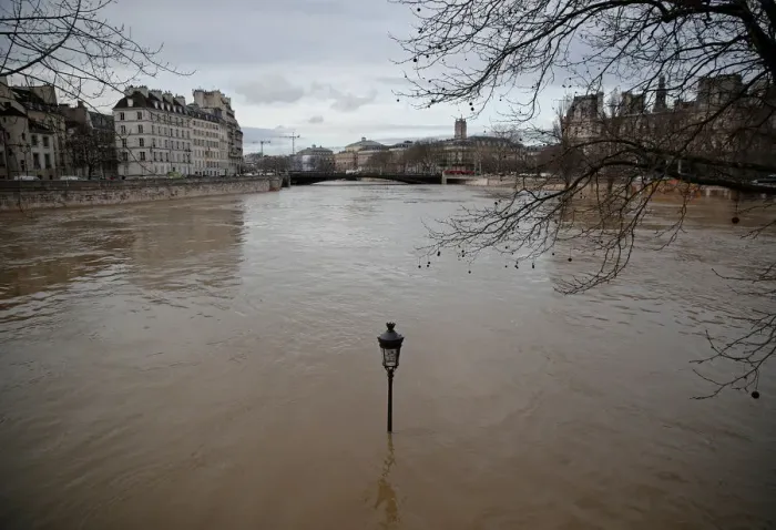 Framed Print : A street-lamp is seen on the flooded banks of the Seine River in Paris Framed Print : A street-lamp is seen on the flooded banks of the Seine River in Paris