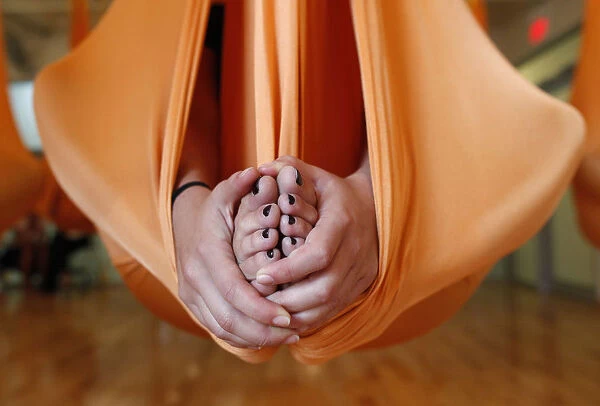 A student takes part in an antigravity yoga class at the Om Factory in New York