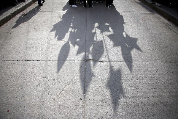 Students cast their shadows during a parade to celebrate Mothers Day in Chilapa de