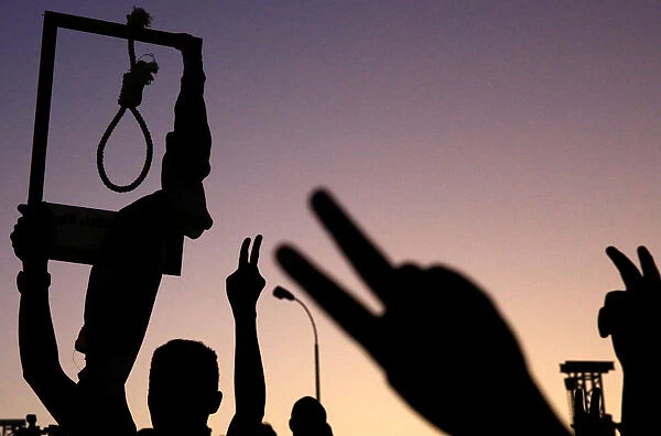 A Sudanese demonstrator carries a noose and gestures during a mass anti-government