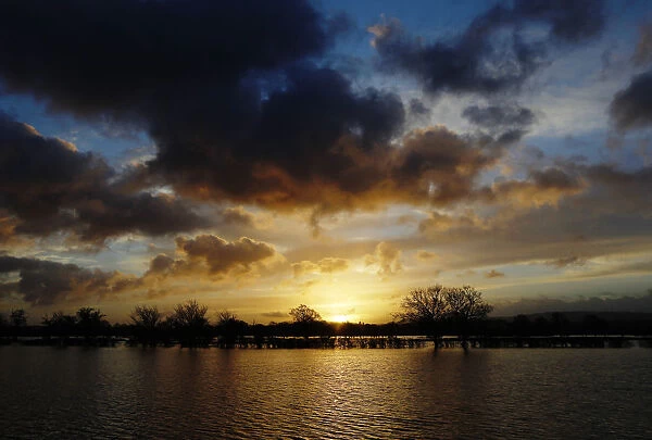 The sun rises over flooded fields at Pulborough