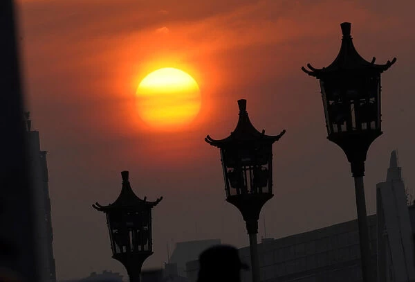 The sun rises at Tiananmen Square ahead of the seventh plenary session of the NPC in