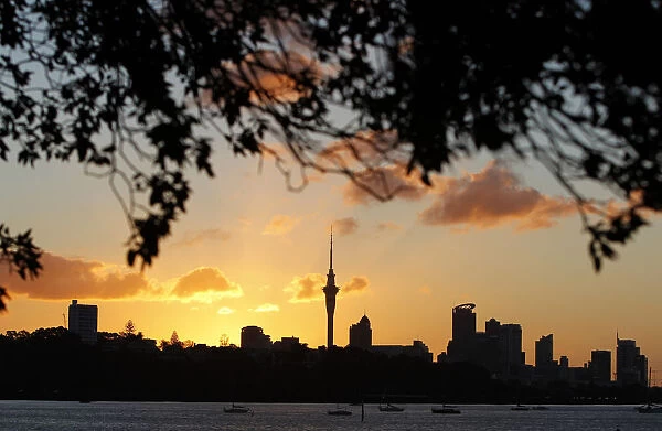 The sun sets over Auckland city